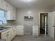 A kitchen with white cabinets, updated hardware, and stainless steel appliances at 718 N Hairston Rd, Stone Mountain, GA 30083