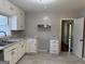 A kitchen with white cabinets, updated hardware, and stainless steel appliances at 718 N Hairston Rd, Stone Mountain, GA 30083