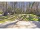 Large backyard with a wooden deck, lush lawn, and storage shed at 4247 Windward Ln, Norcross, GA 30093