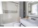 Bathroom features a shower-tub combo, toilet, vanity sink and a storage cabinet at 4247 Windward Ln, Norcross, GA 30093