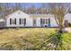 Charming ranch-style home featuring a well-manicured front yard with blue adirondack chairs at 4247 Windward Ln, Norcross, GA 30093