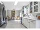 Charming kitchen features stainless steel appliances, white cabinets, marble countertop with dining area at 4247 Windward Ln, Norcross, GA 30093