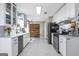 This kitchen features stainless steel appliances, white cabinets, marble countertop and a wooden barn door at 4247 Windward Ln, Norcross, GA 30093