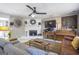 Cozy living area with fireplace, a large TV, a piano, and comfortable sofas at 4247 Windward Ln, Norcross, GA 30093