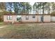 Rear view of a cozy home featuring a sliding glass door and a small wooden porch with a ladder at 105 Woodfield Rd, Covington, GA 30014