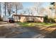 Charming single-story home featuring a wooden deck, well-maintained lawn, and a parked red Ford SUV at 105 Woodfield Rd, Covington, GA 30014