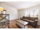 Inviting living room with hardwood floors, bright natural light, and a comfortable brown sofa at 105 Woodfield Rd, Covington, GA 30014