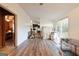 Open-concept space with hardwood floors, showcasing flow between rooms and natural light through sliding glass doors at 105 Woodfield Rd, Covington, GA 30014