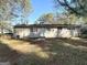 Backyard view of home with exterior in brick and neutral siding, windows and a white rear entry door at 3395 Longleaf Dr, Decatur, GA 30032
