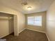 Cozy bedroom with plush carpeting, neutral walls, and a closet with shelving for storage at 3395 Longleaf Dr, Decatur, GA 30032