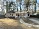Single-story home featuring a covered front porch, neutral exterior paint, and manicured landscaping at 3395 Longleaf Dr, Decatur, GA 30032