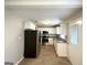 Modern kitchen with stainless steel appliances, granite countertops, white cabinets, and wood-look floors at 3395 Longleaf Dr, Decatur, GA 30032
