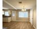 Bright eat-in kitchen featuring wood-look floors, white cabinetry, granite countertops and modern fixtures at 3395 Longleaf Dr, Decatur, GA 30032
