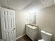 Basement bathroom featuring a granite vanity, updated mirror, and vinyl flooring at 3558 Turner Heights Dr, Decatur, GA 30032