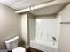 Bathroom featuring a white tiled shower/tub and a toilet at 3558 Turner Heights Dr, Decatur, GA 30032