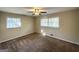 Cozy bedroom with neutral carpet, two windows, and a ceiling fan at 3558 Turner Heights Dr, Decatur, GA 30032