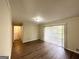 Open living area with sliding glass doors, wood floors, and neutral walls at 3558 Turner Heights Dr, Decatur, GA 30032