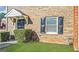 Charming brick townhome featuring a covered entrance and manicured lawn at 4517 Golf Vista Cir, Decatur, GA 30035