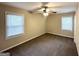 Inviting bedroom featuring two windows, neutral paint, and ceiling fan at 2000 Marvin Sw Ln, Atlanta, GA 30311