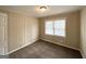 Cozy bedroom with neutral carpet, paneled walls and a window at 2000 Marvin Sw Ln, Atlanta, GA 30311