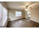 Bright living room featuring sleek flooring, fresh paint, large window, and a ceiling fan at 2000 Marvin Sw Ln, Atlanta, GA 30311
