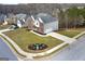 A manicured front lawn of a two-story brick home with an island of plants in the cul-de-sac at 253 Summit View Dr, Mcdonough, GA 30253