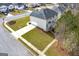 Aerial view of a home with a large green yard, a driveway, and a stone walkway around the side at 253 Summit View Dr, Mcdonough, GA 30253