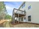 Rear exterior of the two-story home featuring a wooden deck with staircase at 253 Summit View Dr, Mcdonough, GA 30253