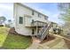 Two-story home with a wooden deck and stairs leading to the backyard at 253 Summit View Dr, Mcdonough, GA 30253