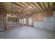 Unfinished basement with exposed ceiling insulation and the frame for the rooms in the basement at 253 Summit View Dr, Mcdonough, GA 30253