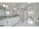 Modern bathroom featuring a double vanity, white cabinets, and a glass-enclosed shower, creating a spa-like experience at 253 Summit View Dr, Mcdonough, GA 30253