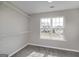 Cozy bedroom with carpeted floors, a window, and built-in closet organizers, providing a comfortable and organized space at 253 Summit View Dr, Mcdonough, GA 30253