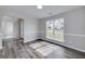 Dining area with a large window providing natural light and views, complemented by stylish gray wood flooring at 253 Summit View Dr, Mcdonough, GA 30253