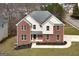 Two-story brick home with a manicured lawn and landscaping around the front of the home at 253 Summit View Dr, Mcdonough, GA 30253