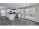 Spacious kitchen featuring white cabinets, stainless steel appliances, granite countertops and gray wood floors at 253 Summit View Dr, Mcdonough, GA 30253