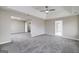 Large main bedroom featuring neutral tones, a tray ceiling with a ceiling fan, and carpeted floors, creating a serene retreat at 253 Summit View Dr, Mcdonough, GA 30253