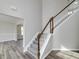 Inviting foyer view featuring staircase with carpeted steps and wood railing, offering an elegant transition to the upper level at 253 Summit View Dr, Mcdonough, GA 30253