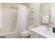 Bright bathroom featuring a shower-tub combination, floating shelves, toilet, vanity, and neutral color palette at 4030 Cresent Walk Ne Ln, Suwanee, GA 30024