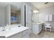 Bathroom features a double vanity, tub, tiled floors, and decorative mirrors at 4030 Cresent Walk Ne Ln, Suwanee, GA 30024