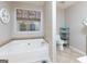 Bathroom features a large soaking tub with tile surround, and tile flooring at 4030 Cresent Walk Ne Ln, Suwanee, GA 30024