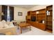 Bedroom with built-in shelving, sitting area, and natural light creates a cozy space for relaxation and work at 4030 Cresent Walk Ne Ln, Suwanee, GA 30024