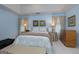 A spacious main bedroom featuring vaulted ceilings, soft blue walls, and neutral decor at 4030 Cresent Walk Ne Ln, Suwanee, GA 30024