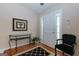 Bright foyer features wood floors, a glass console table, and classic black accents at 4030 Cresent Walk Ne Ln, Suwanee, GA 30024