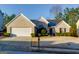 Charming single-story home with a white brick exterior, well-manicured lawn, and attached two-car garage at 4030 Cresent Walk Ne Ln, Suwanee, GA 30024