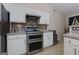 Modern kitchen showcasing stainless steel appliances, white cabinets, and decorative tile backsplash at 4030 Cresent Walk Ne Ln, Suwanee, GA 30024