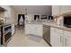 Kitchen features white cabinets, stainless steel appliances, lots of counter space, and modern tile backsplash at 4030 Cresent Walk Ne Ln, Suwanee, GA 30024