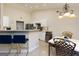 Modern kitchen with white cabinetry, stainless appliances, and a cozy breakfast bar with seating at 4030 Cresent Walk Ne Ln, Suwanee, GA 30024