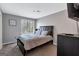 Well-lit bedroom with a large window, a bed with padded headboard and neutral color scheme at 5545 Circlestone Ln, Stone Mountain, GA 30083