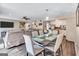 Open-concept living area featuring a dining table, living room, and a glimpse into the modern kitchen with stainless appliances at 5545 Circlestone Ln, Stone Mountain, GA 30083