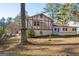 Exterior picture of a two-story home with a backyard covered in pine needles and surrounded by tall trees at 9100 Settlers Grove Ne Rd, Covington, GA 30014